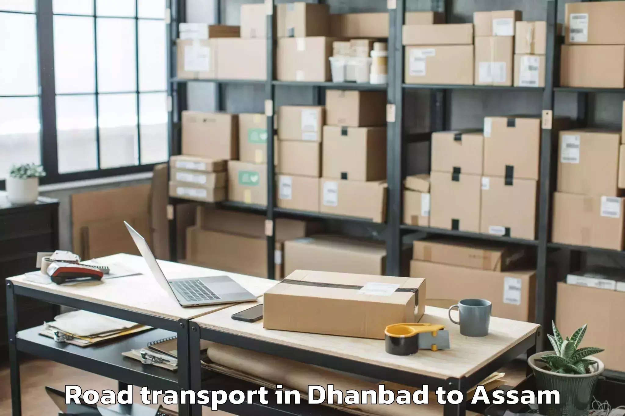 Quality Dhanbad to Mikirbheta Road Transport